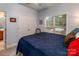 Bedroom featuring a blue bedspread, view to the back yard, closet and ensuite at 2518 Wellesbourne Ln, Sherrills Ford, NC 28673