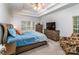 Relaxing bedroom featuring a tray ceiling, ceiling fan, and a large window for natural light at 2518 Wellesbourne Ln, Sherrills Ford, NC 28673