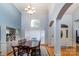 Elegant dining room with large table, chandelier, and arched entryways showcasing refined architectural details at 2518 Wellesbourne Ln, Sherrills Ford, NC 28673