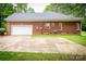 Rear exterior view showing brick home with garage and large concrete driveway at 2518 Wellesbourne Ln, Sherrills Ford, NC 28673