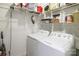 Laundry room with white washer and dryer and wire shelves at 2518 Wellesbourne Ln, Sherrills Ford, NC 28673