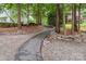 Beautifully landscaped path that runs between properties with mature trees at 2518 Wellesbourne Ln, Sherrills Ford, NC 28673