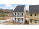 Charming two-story home featuring double balconies, white pillars, black railings, and a welcoming front entrance at 5830 Pittmon Ln, Kannapolis, NC 28081