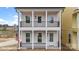 Charming two-story home featuring double balconies, white pillars, black railings, and a welcoming front entrance at 5830 Pittmon Ln, Kannapolis, NC 28081