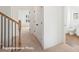 Bright hallway with a wooden banister and multiple closets at 5830 Pittmon Ln, Kannapolis, NC 28081