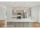 Well-lit kitchen featuring a central island, modern appliances, and stylish pendant lighting at 5830 Pittmon Ln, Kannapolis, NC 28081