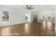 Open-concept living room boasts hardwood floors, recessed lighting, and large windows, flowing seamlessly into the kitchen at 5830 Pittmon Ln, Kannapolis, NC 28081