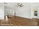 Open-concept living space boasts hardwood floors, lots of natural light, and transitions to the kitchen at 5830 Pittmon Ln, Kannapolis, NC 28081