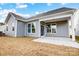 Gray house exterior with covered patio and grassy backyard at 106 N Dunlavin Way # 4, Mooresville, NC 28115