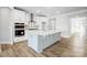 Modern kitchen with island, stainless steel appliances, and white cabinetry at 106 N Dunlavin Way # 4, Mooresville, NC 28115