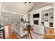 Open living room with fireplace, built-in shelving, large windows and doors for natural light at 2504 Stoneview Ct, Denver, NC 28037