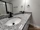 Close up of bathroom vanity with granite countertop and black faucet hardware at 9609 Stokes Ferry Rd, Gold Hill, NC 28071