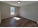 Bedroom with wood-look flooring and a window letting in natural light at 9609 Stokes Ferry Rd, Gold Hill, NC 28071