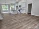 Open-concept kitchen with a central island, white cabinets, granite countertops, and stainless steel appliances at 9609 Stokes Ferry Rd, Gold Hill, NC 28071