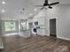 Open-concept kitchen with a central island, white cabinets, granite countertops, and stainless steel appliances at 9609 Stokes Ferry Rd, Gold Hill, NC 28071