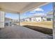 A covered back porch offers a tranquil outdoor space overlooking the backyard and neighboring homes at 121 Clawton Loop, Mooresville, NC 28115