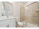 Bright bathroom features a tiled shower with a sliding glass door, a toilet, and a vanity with a sink at 121 Clawton Loop, Mooresville, NC 28115