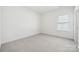 Sunlit carpeted bedroom featuring neutral paint and a window at 121 Clawton Loop, Mooresville, NC 28115