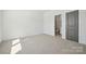 Carpeted bedroom with a door and ensuite bathroom at 121 Clawton Loop, Mooresville, NC 28115