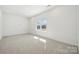 Bright bedroom has plush carpeting and a window that lets in lots of natural light at 121 Clawton Loop, Mooresville, NC 28115
