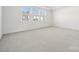 Spacious bedroom featuring plush carpeting, neutral paint, and a large window at 121 Clawton Loop, Mooresville, NC 28115