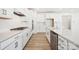 A modern white kitchen featuring stainless steel appliances, a gas cooktop, and a large island at 121 Clawton Loop, Mooresville, NC 28115
