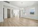 Spacious living room with large windows, crown molding, and a staircase, offering a bright, open feel at 121 Clawton Loop, Mooresville, NC 28115