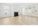Cozy living room with a traditional fireplace and ample natural light from large windows at 121 Clawton Loop, Mooresville, NC 28115