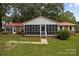 Brick ranch home with red metal roof, screened porch, and landscaped yard at 3338 Passmore Rd, Rock Hill, SC 29730