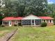 Front view of brick ranch with red metal roof and sunroom at 3338 Passmore Rd, Rock Hill, SC 29730