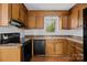 Kitchen with wood cabinets and black appliances at 3338 Passmore Rd, Rock Hill, SC 29730