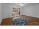 Living room with hardwood floors, blue patterned rug, and view of screened porch at 3338 Passmore Rd, Rock Hill, SC 29730