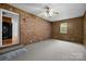 View of a bonus room showcasing carpet floors, brick wall, window and a ceiling fan at 3338 Passmore Rd, Rock Hill, SC 29730