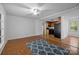 Spacious living room with wood floors that opens to the kitchen with modern appliances at 3338 Passmore Rd, Rock Hill, SC 29730