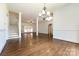 Bright dining room with hardwood floors and elegant chandelier at 426 Saint Michaels Way, Fort Mill, SC 29708