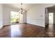 Well-lit dining room with hardwood floors, a chandelier, and access to kitchen at 426 Saint Michaels Way, Fort Mill, SC 29708