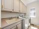 Bright laundry room, features washer, dryer, and built-in cabinets at 426 Saint Michaels Way, Fort Mill, SC 29708