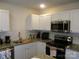 Modern kitchen with stainless steel appliances and granite countertops at 6720 Cypress Tree Ln, Charlotte, NC 28215