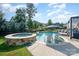 An in-ground pool and attached hot tub are surrounded by lounge chairs and umbrellas at 7037 Hyde Park Dr, Indian Trail, NC 28079