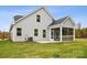 House exterior showcasing a screened porch and grassy backyard at 8336 Acadia Pkwy, Sherrills Ford, NC 28673