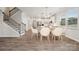 Bright dining area with modern light fixture and view into kitchen at 8336 Acadia Pkwy, Sherrills Ford, NC 28673