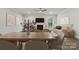 Dining area with a wooden table and chairs, adjacent to the living room at 8336 Acadia Pkwy, Sherrills Ford, NC 28673