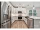 Modern kitchen with stainless steel appliances and white cabinets at 8336 Acadia Pkwy, Sherrills Ford, NC 28673