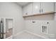 Laundry room with upper cabinets and marble-look flooring at 8336 Acadia Pkwy, Sherrills Ford, NC 28673