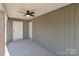 Covered back porch with ceiling fan and exterior door at 528 Moss Springs Rd, Albemarle, NC 28001