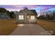 Charming craftsman style home with a welcoming front porch and a spacious driveway at dusk at 528 Moss Springs Rd, Albemarle, NC 28001