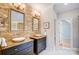 Elegant bathroom with double sinks and stone wall at 2804 Providence View Ln, Charlotte, NC 28270