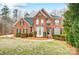 Brick house with a large front yard, landscaping, and a walkway at 2804 Providence View Ln, Charlotte, NC 28270