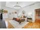 Main bedroom with hardwood floors, large windows, and elegant chandelier at 2804 Providence View Ln, Charlotte, NC 28270