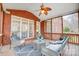 Brick screened porch with ceiling fan and comfortable seating area at 2804 Providence View Ln, Charlotte, NC 28270